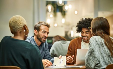 Four people working at a table.